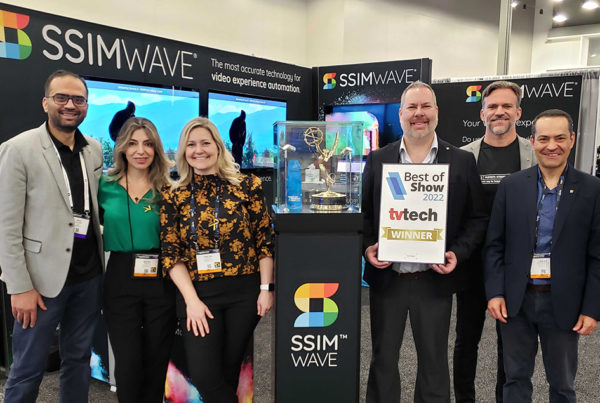 The SSIMWAVE team standing at their booth at NAB with the Product of the Year and Best in Show awards